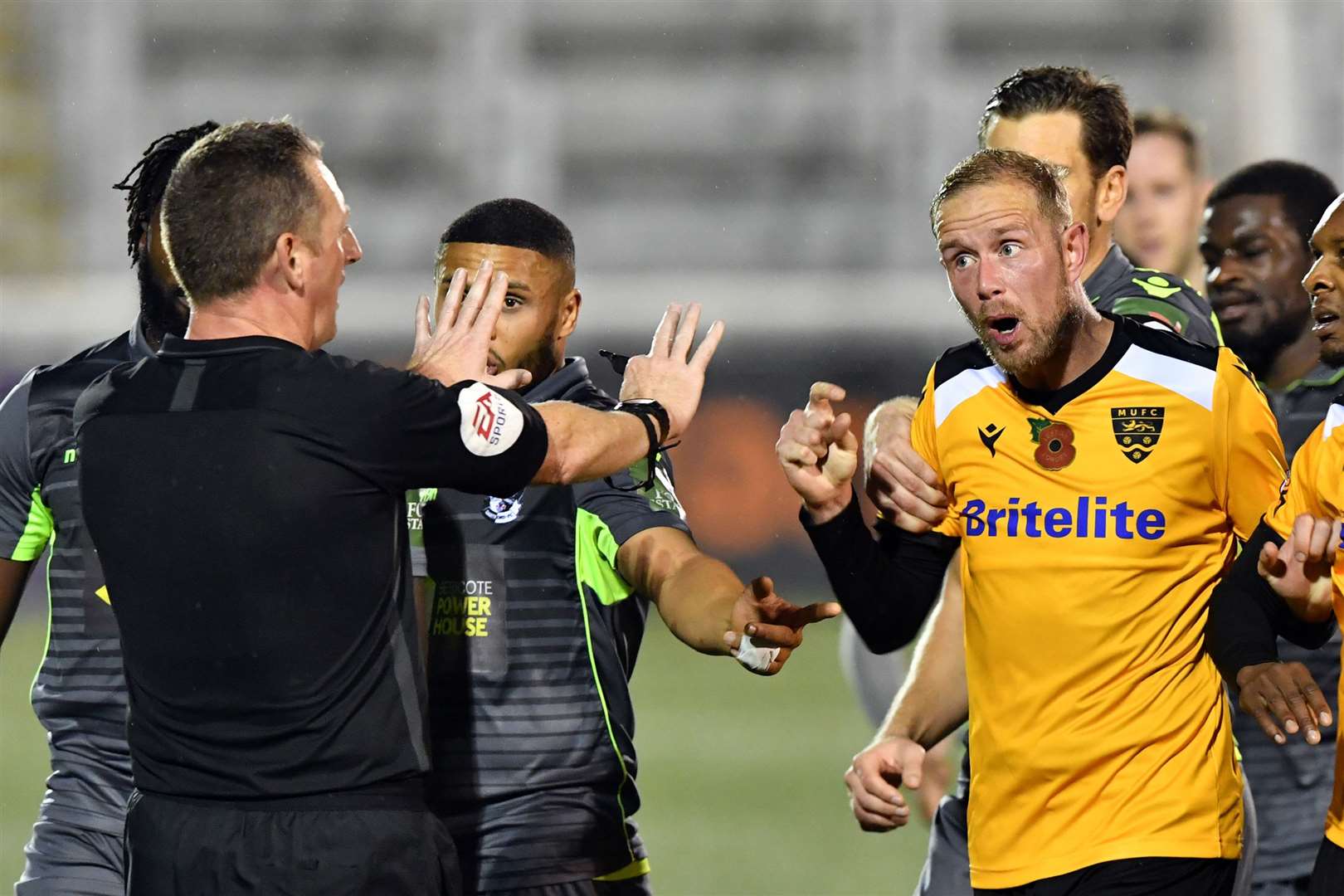 Referee Phil Staynings holds firm amid protests from Maidstone striker Scott Rendell Picture: Keith Gillard