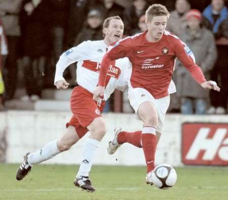 Fleet striker Michael Gash drives forward against Kettering