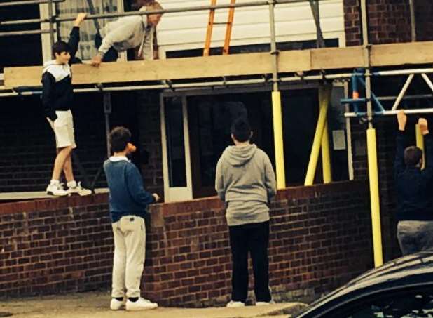 Teenagers were seen to be climbing on scaffolding and throwing stones at the windows of an elderly residents' home