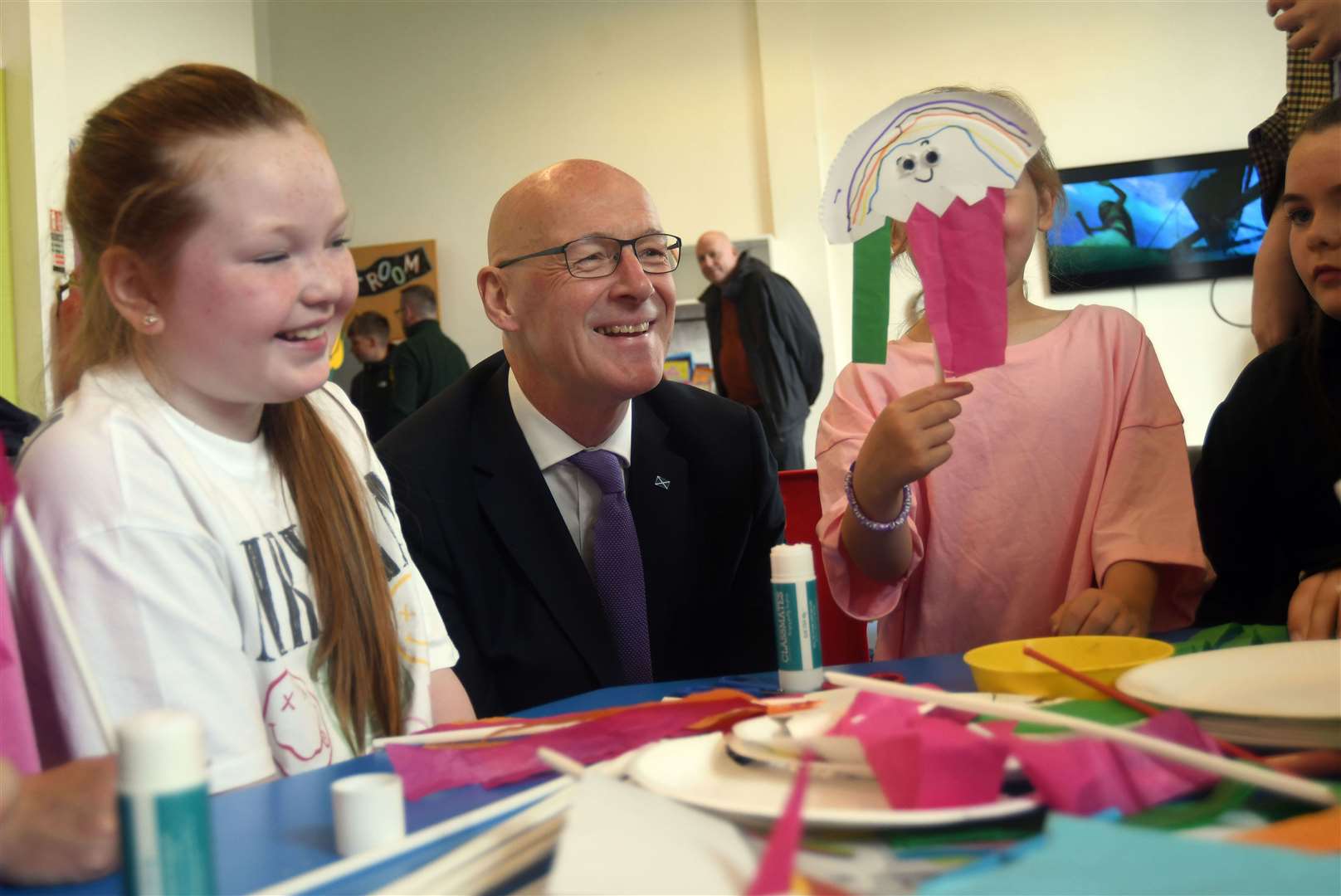 Mr Swinney joined in with children during an arts and crafts session during a visit to the Jeely Piece Club in the city (Michael Boyd/PA)