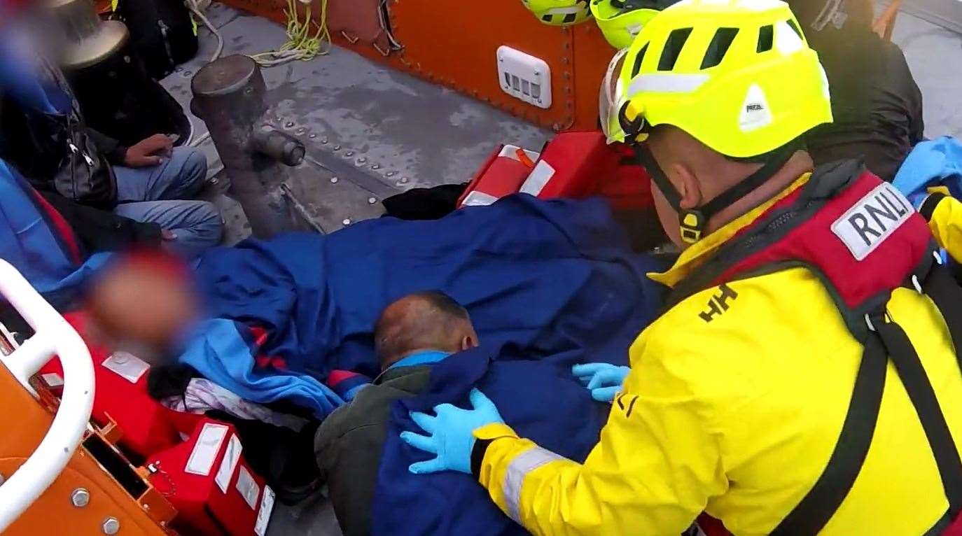 RNLI volunteers care for a family rescued from the waters of the English Channel. Picture: RNLI