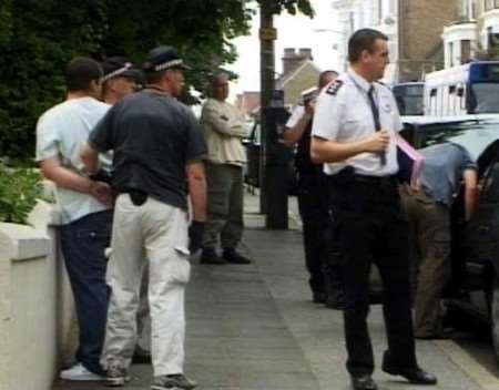 One of the suspects is arrested by armed officers by the roadside. Pictures: JIM YARLETT