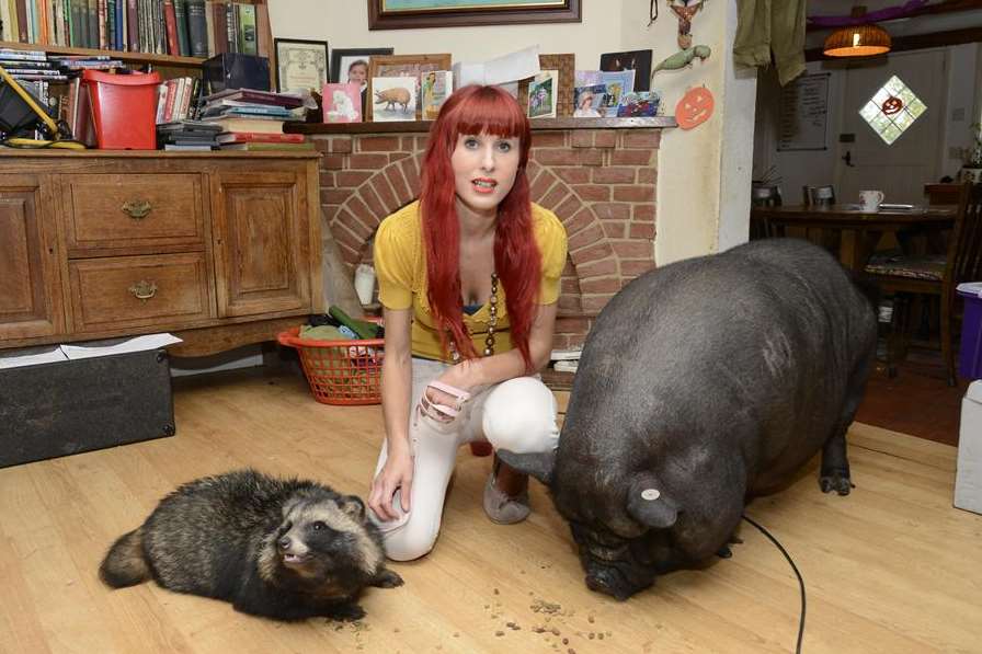 Maria Cooper with Martha the racoon dog and Dinky the pig