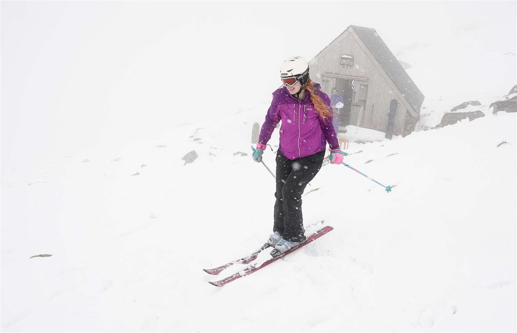 A skier makes her way down the slope at the Lake District Ski Club on Raise, next to Helvellyn, after an unseasonal May snowfall (Owen Humphreys/PA)