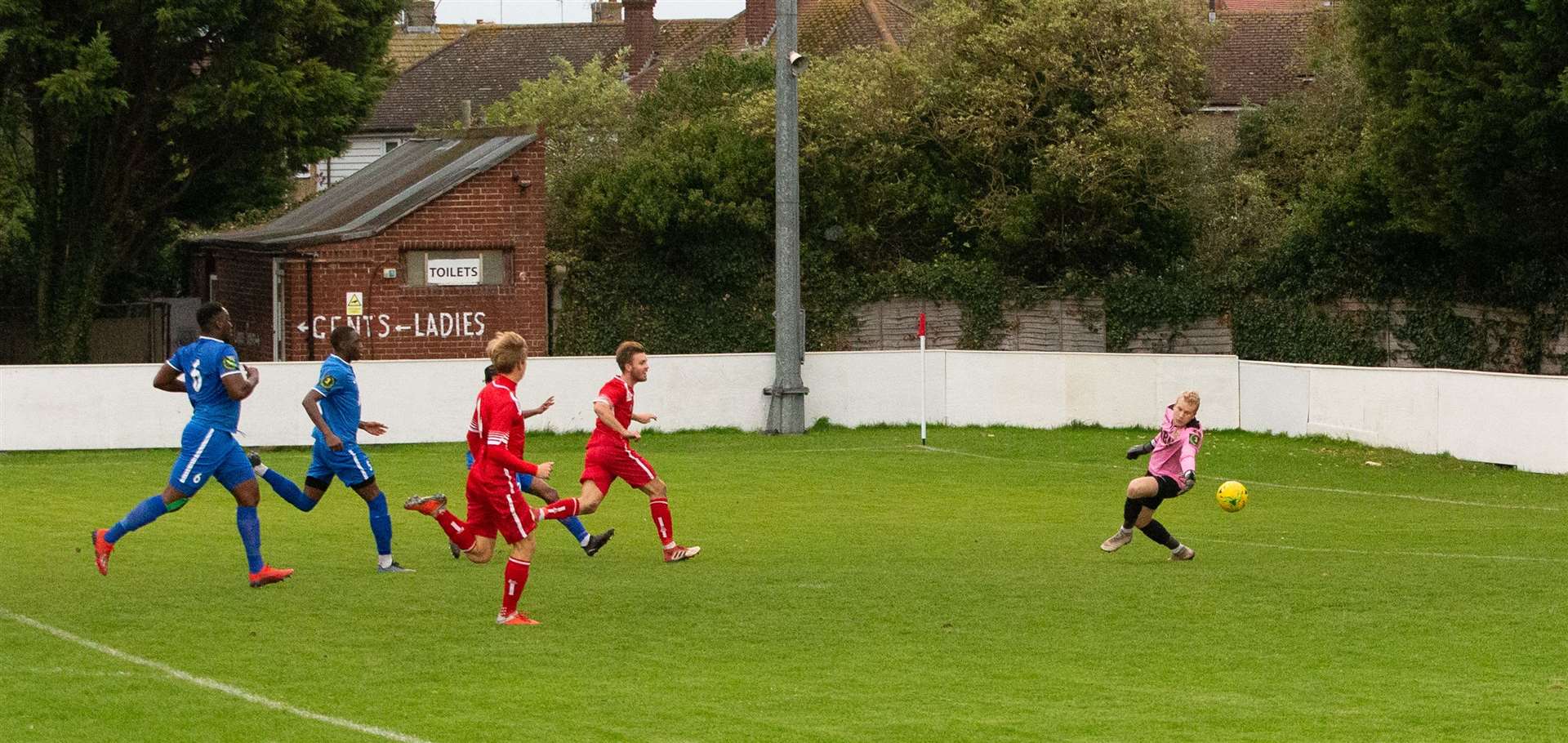 Whitstable's Aaron Millbank slides the ball past VCD goalkeeper Matt Funnell