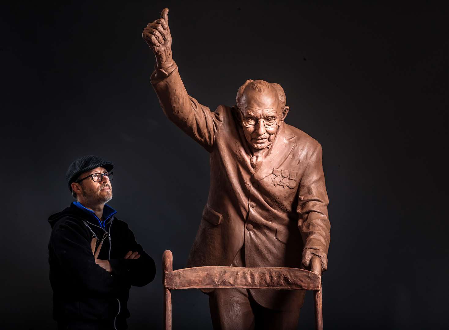 Andrian Melka puts the finishing touches to his two-metre high statue of Captain Sir Tom Moore (Danny Lawson/PA)