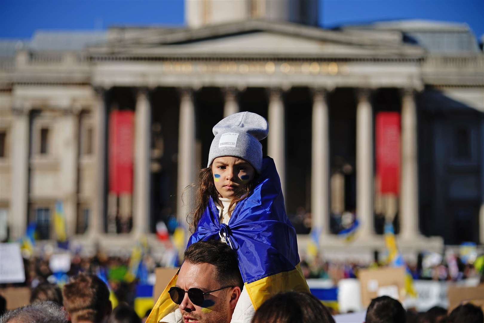 A girl among the crowds at the Trafalgar Square protest. (PA/Aaron Chown)