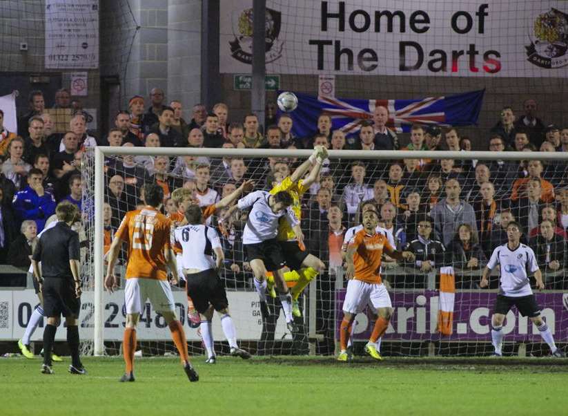 Alan Julian punches as the Luton fans look on Picture: Andy Payton