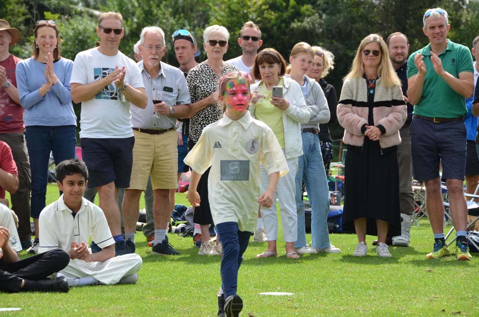 Florrie Turner, aged six, the youngest member of the girls' squad going up to collect her 2021 medal