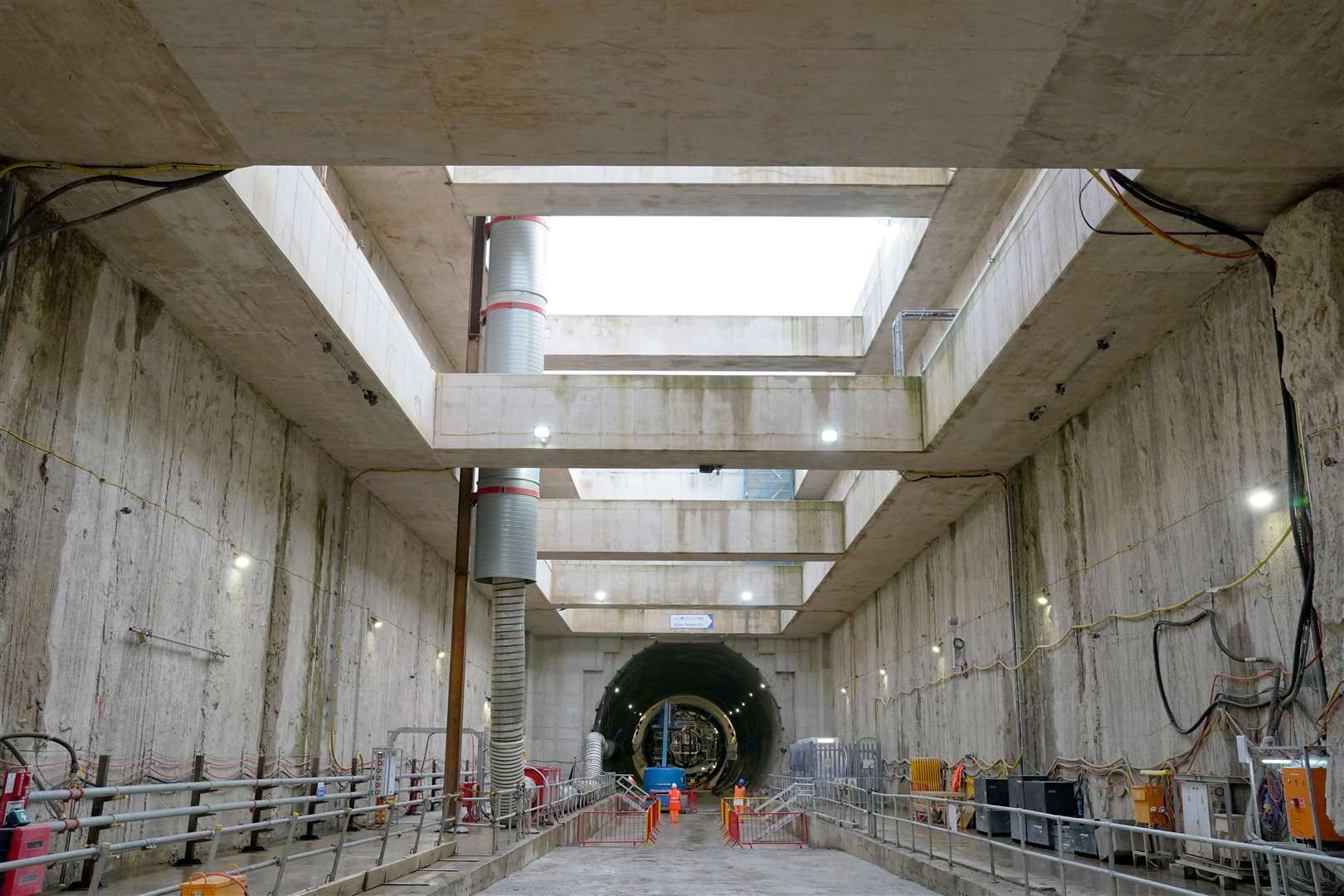 HS2 workers walk towards the upline tunnel at the bottom of the Old Oak Common station box site during preparations for completing tunnelling to London Euston (Jonathan Brady/PA)