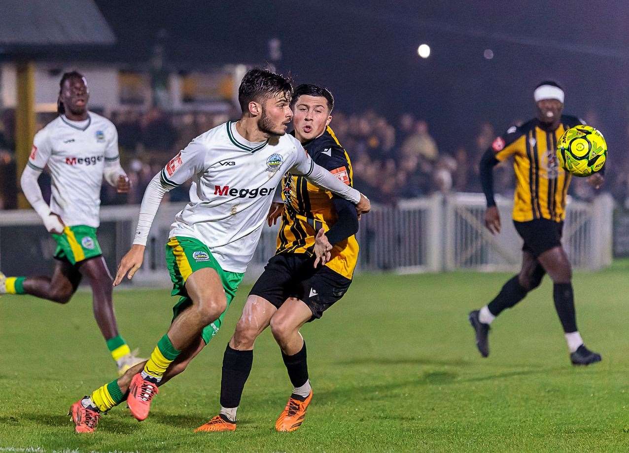 Dover's top scorer George Nikaj does his defensive duties, trying to get away from Folkestone left-back Frankie Morgan in Whites’ 1-0 Isthmian Premier win last Tuesday. Picture: Helen Cooper