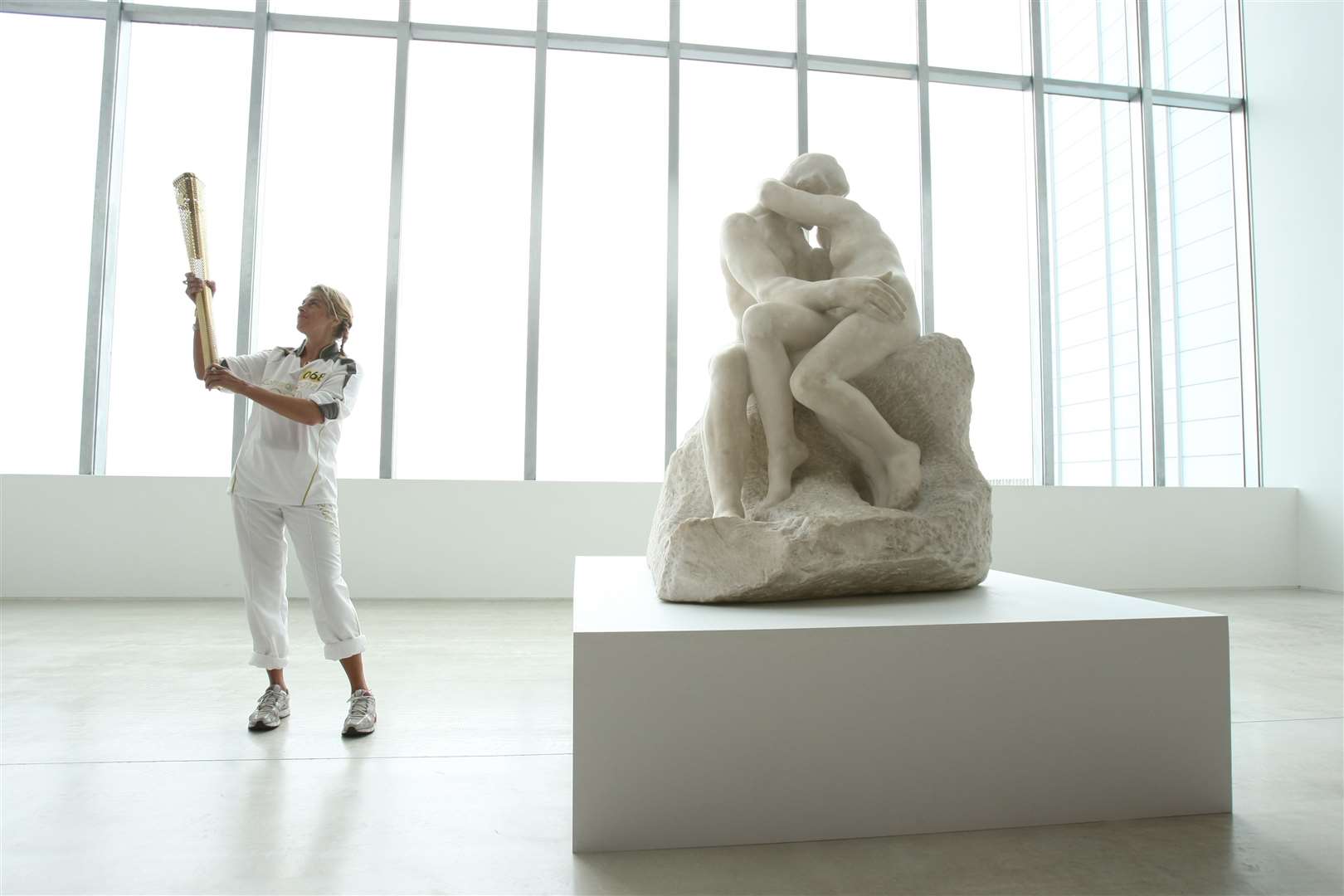 Torchbearer Tracey Emin holds the flame inside the Turner Contemporary. Pic: Locog