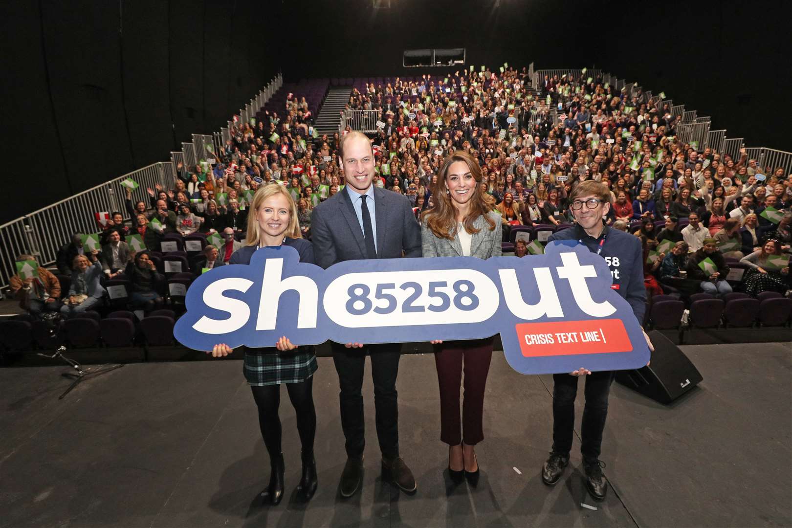 William and Kate on a London theatre stage during a volunteer celebration event with the text helpline Shout (Yui Mok/PA)