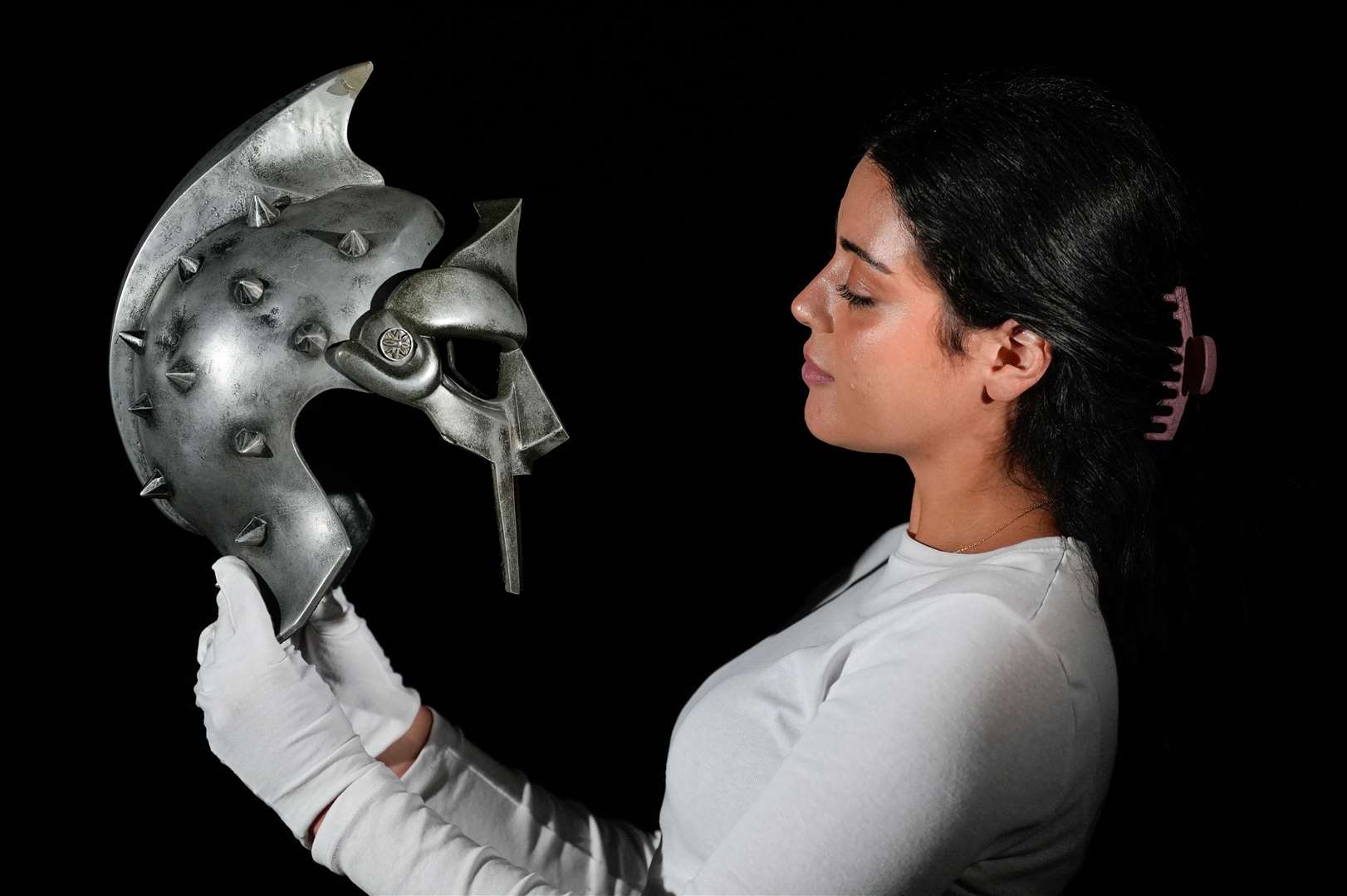 A Propstore employee holds Maximus’ (Russell Crowe) arena helmet and mask (Andrew Matthews/PA)