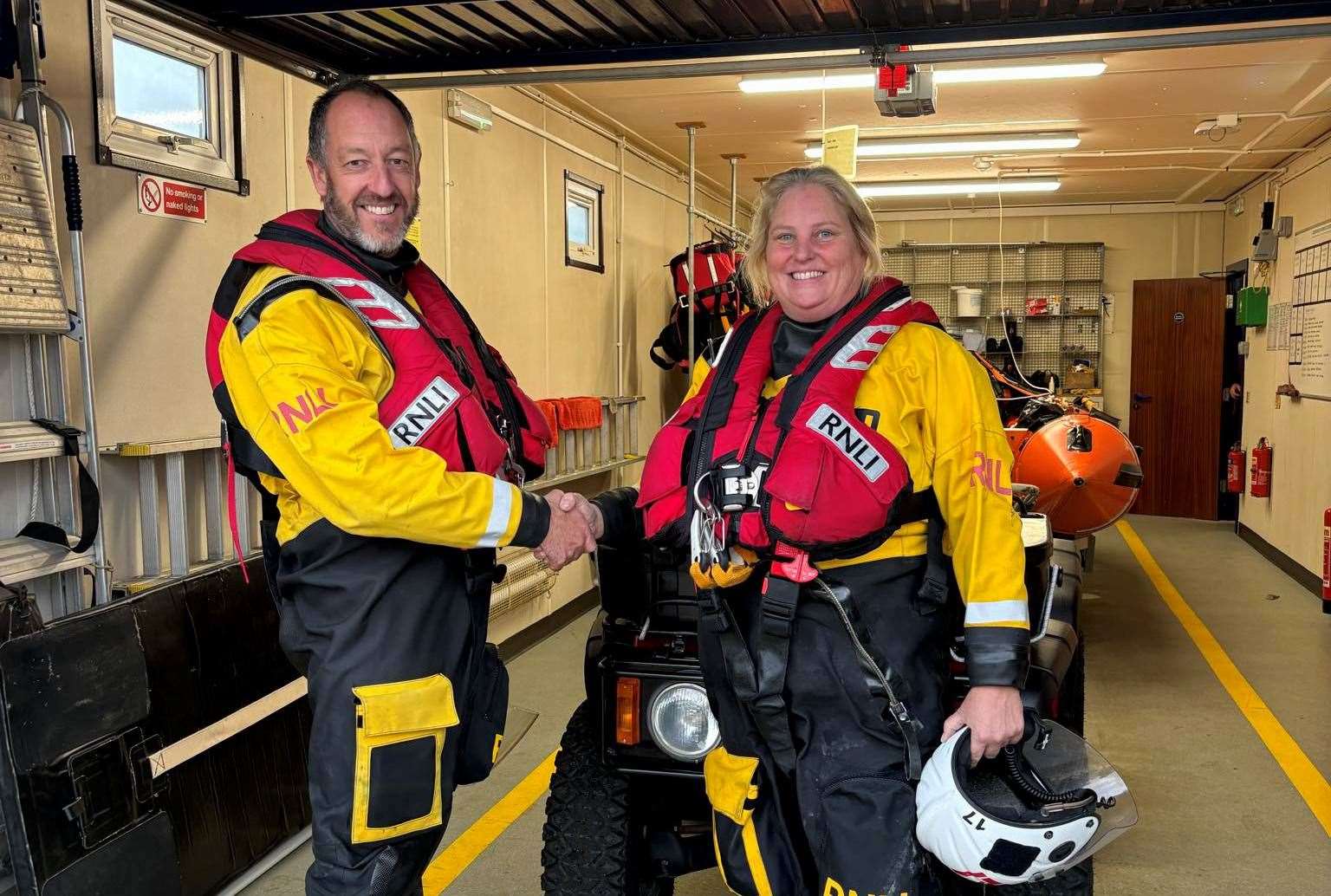 Assessor Dave Needham congratulating new helm Rachel Collier on her achievement. Picture: RNLI