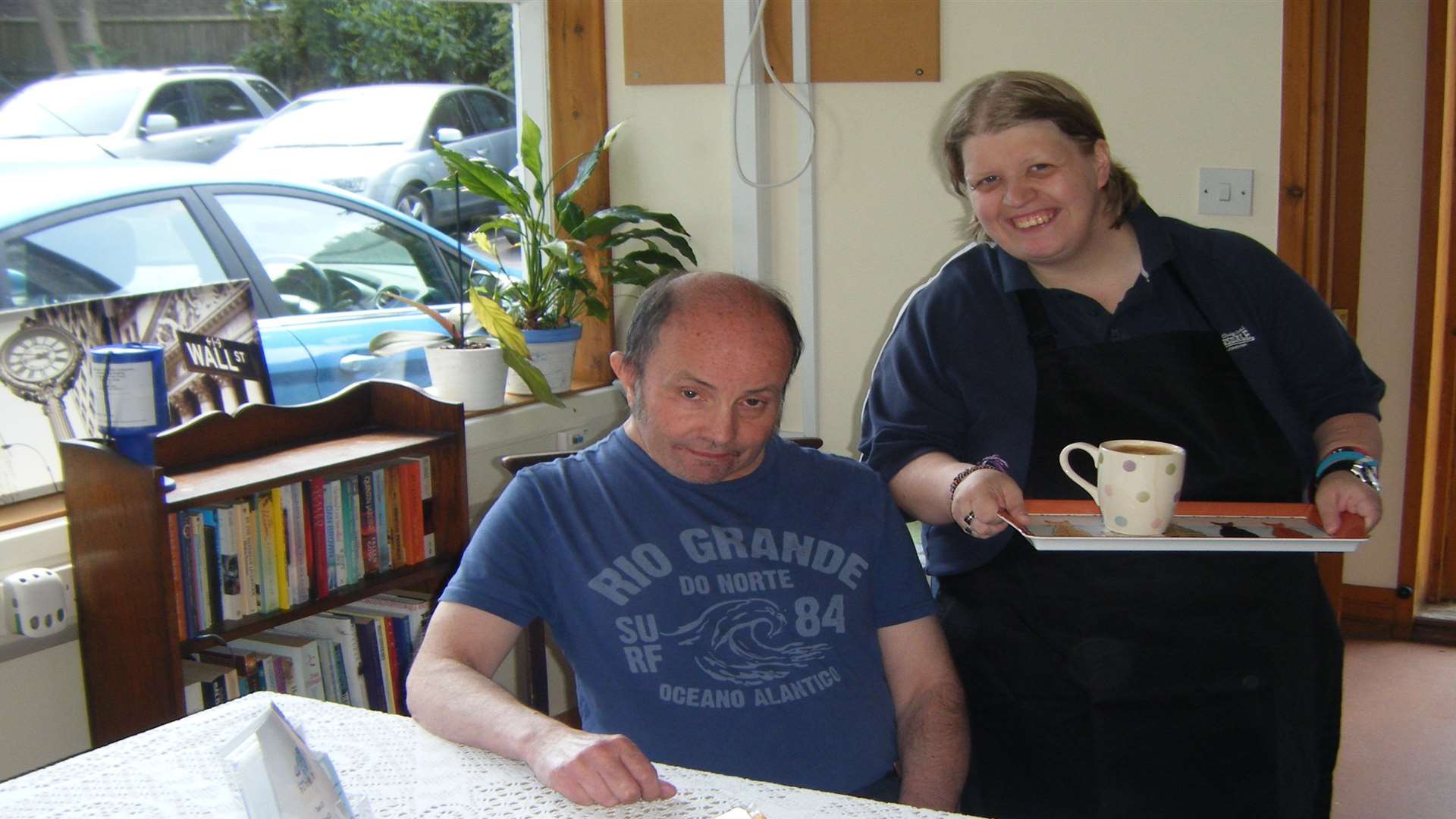 Hope Stevens, resident waitress, serves David Chitty, a fellow resident