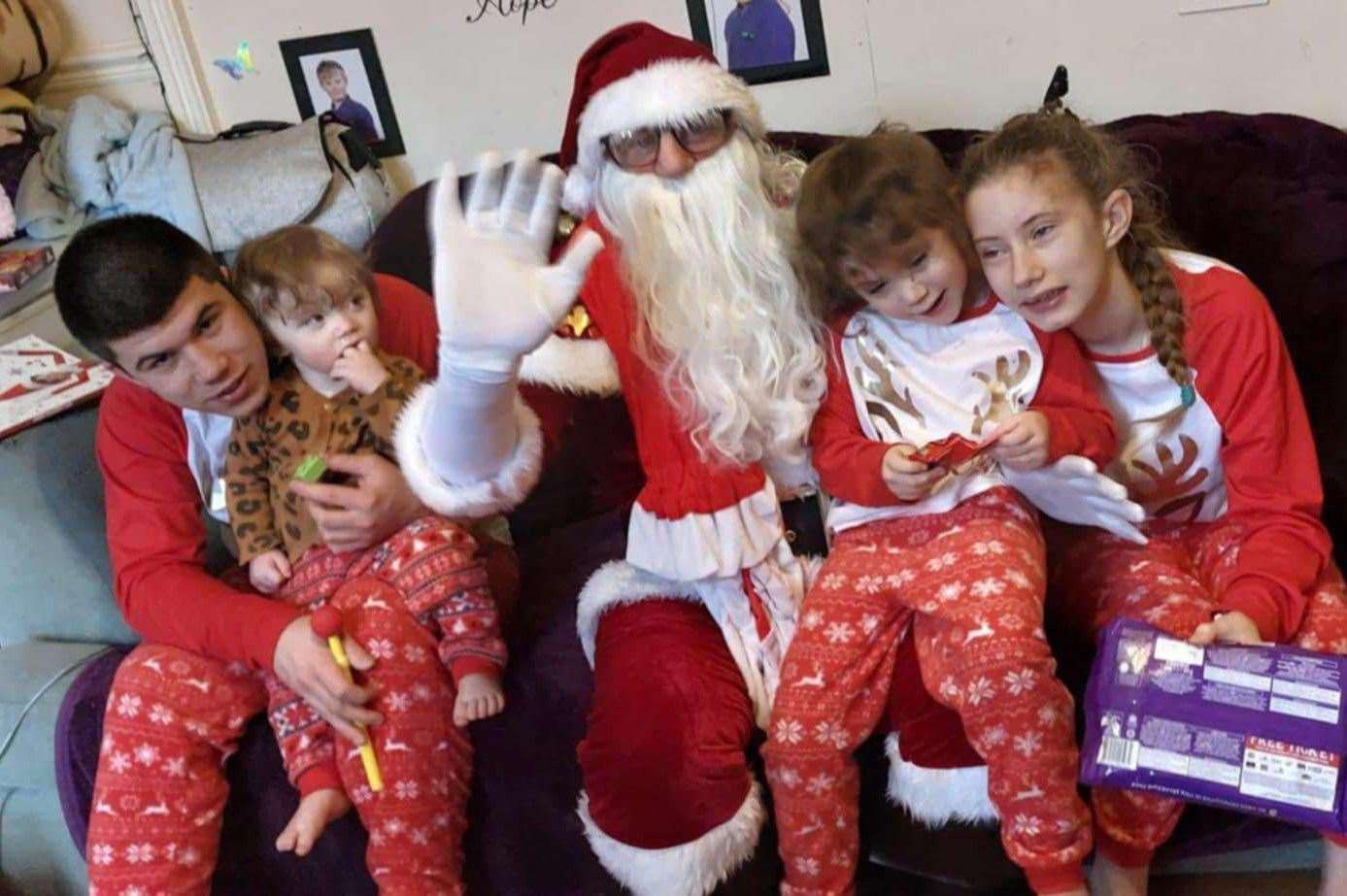 Rob dressed as Father Christmas with grandkids Ashley, Kiara, Baylee and Joseph