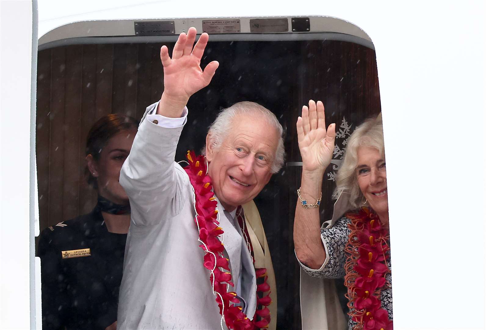 The King and Queen wave as they board an Royal Australian Air Force plane in Samoa at the end of their tour (Chris Jackson/PA)