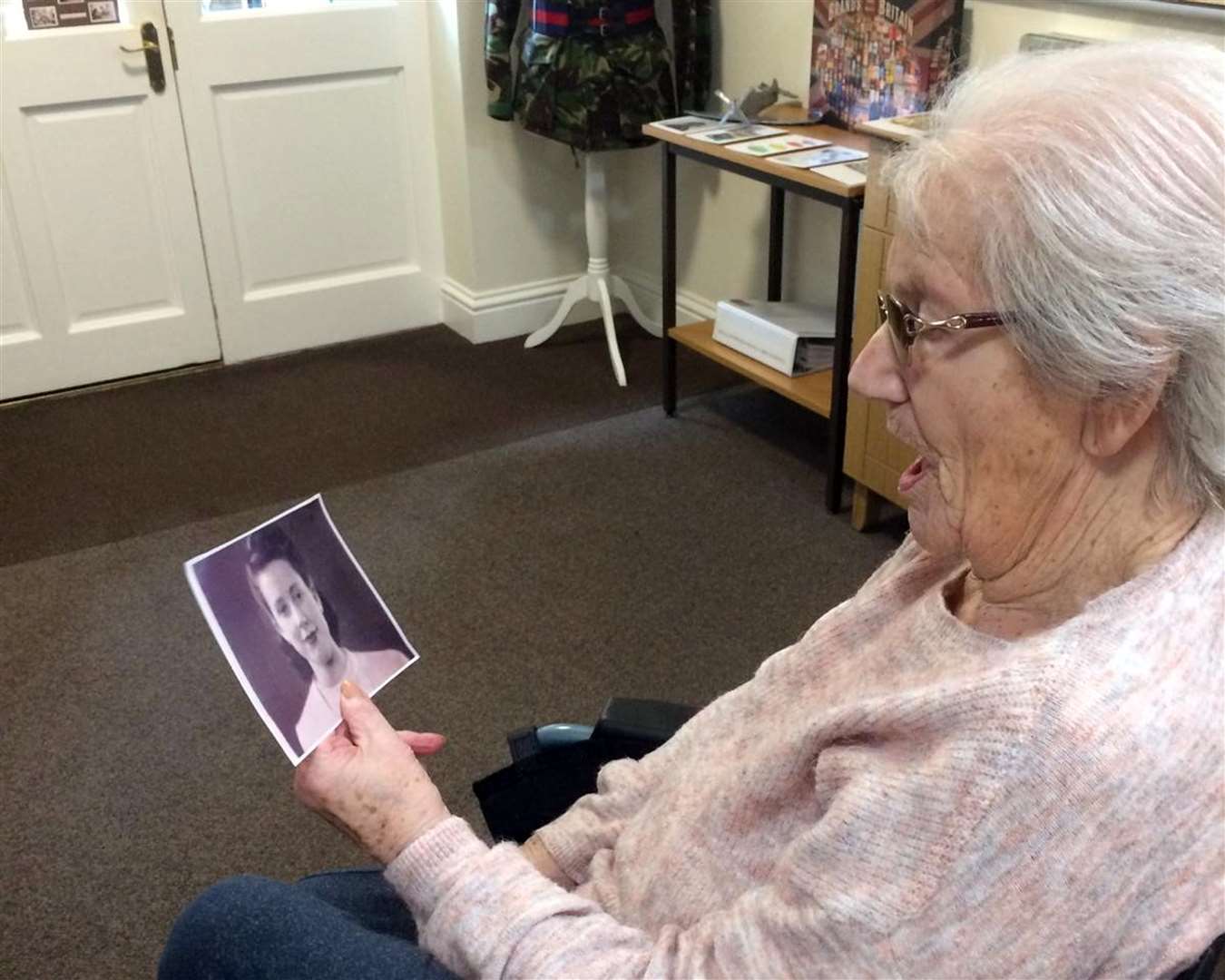 Beryl Burley looks at a picture of her younger self (Handout/PA)