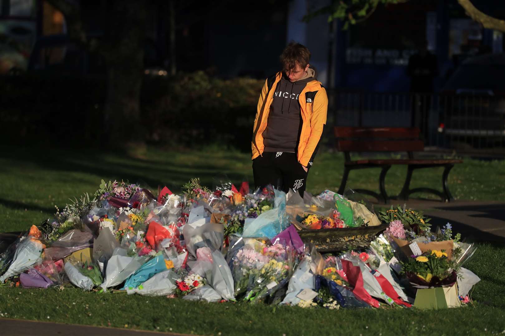 PCSO James’s son Patrick looks at floral tributes left near her family home in Snowdown (Gareth Fuller/PA)