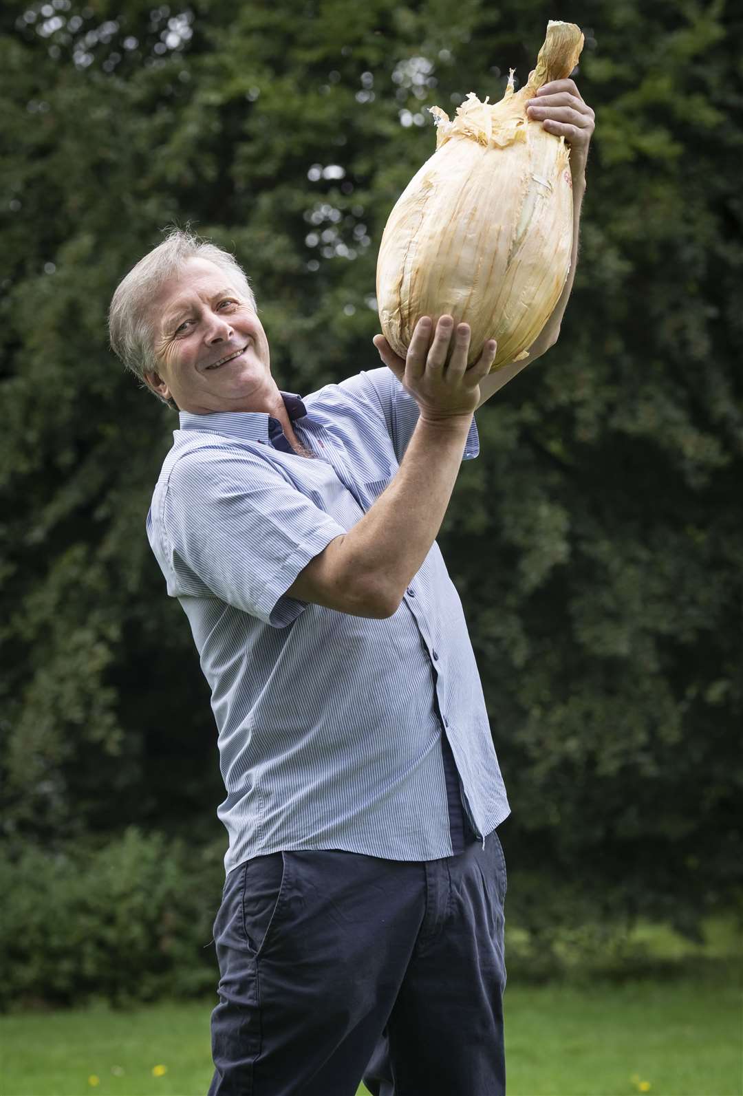 Gareth Griffin with his world record-breaking giant onion that weighs 8.97kg (19.775lb), following the giant vegetable competition at the Harrogate Autumn Flower Show (Danny Lawson/PA)