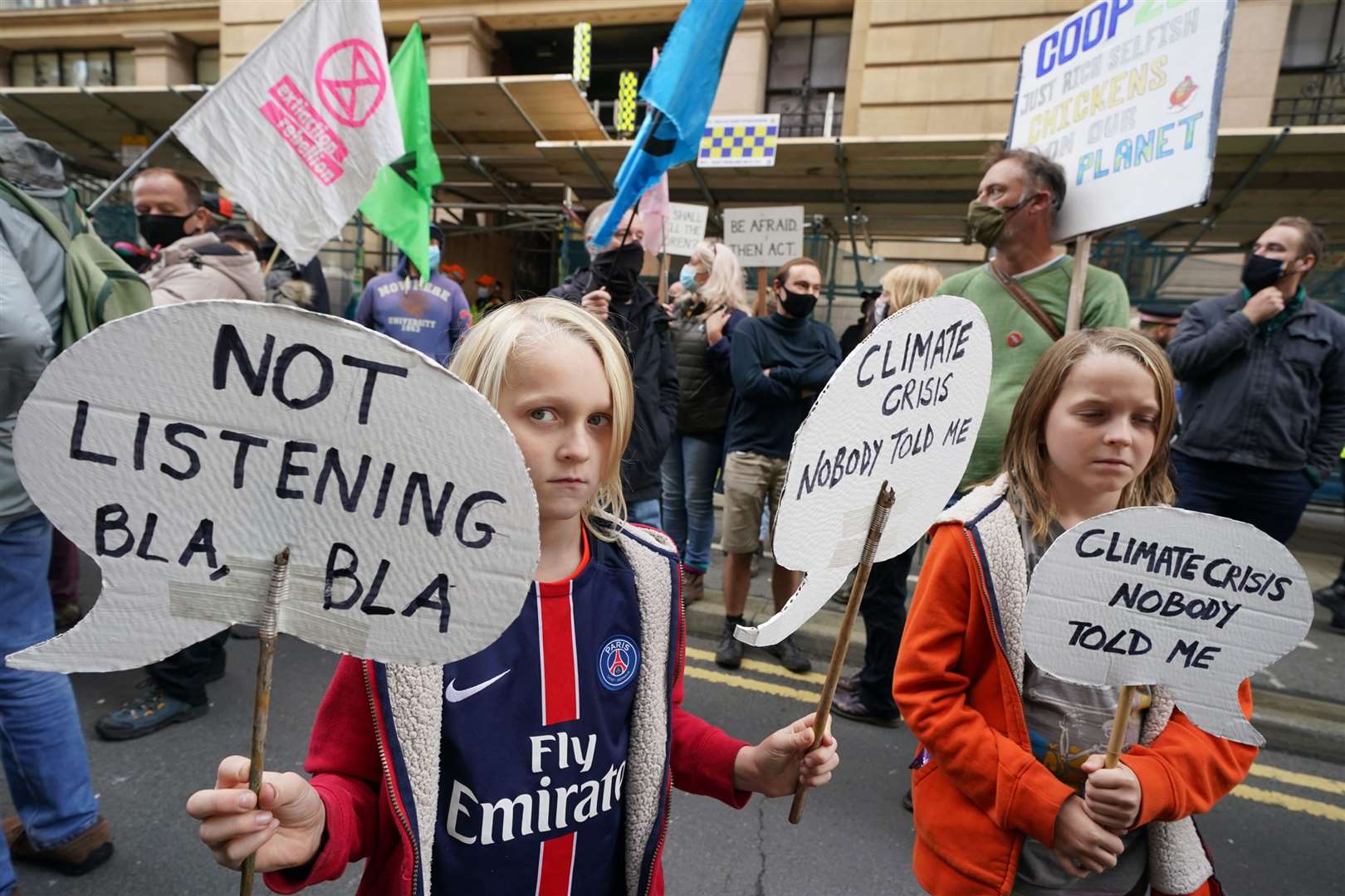 Climate activists take part in a ‘Trillion Dollar Bash’ outside the offices of JP Morgan on Waterloo Street, Glasgow, calling out the bank’s continued profits from and investment into fossil fuel projects and contribution to the suffering caused by the climate crisis (Owen Humphreys/PA)