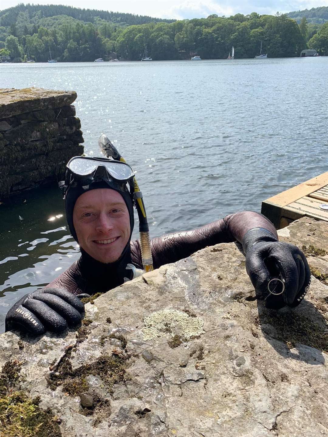 Lake District Divers volunteer Angus Hosking recovering a wedding ring for newlyweds Annabelle and Mick Balchin after it was lost in Lake Windermere (Annabelle Balchin/PA)