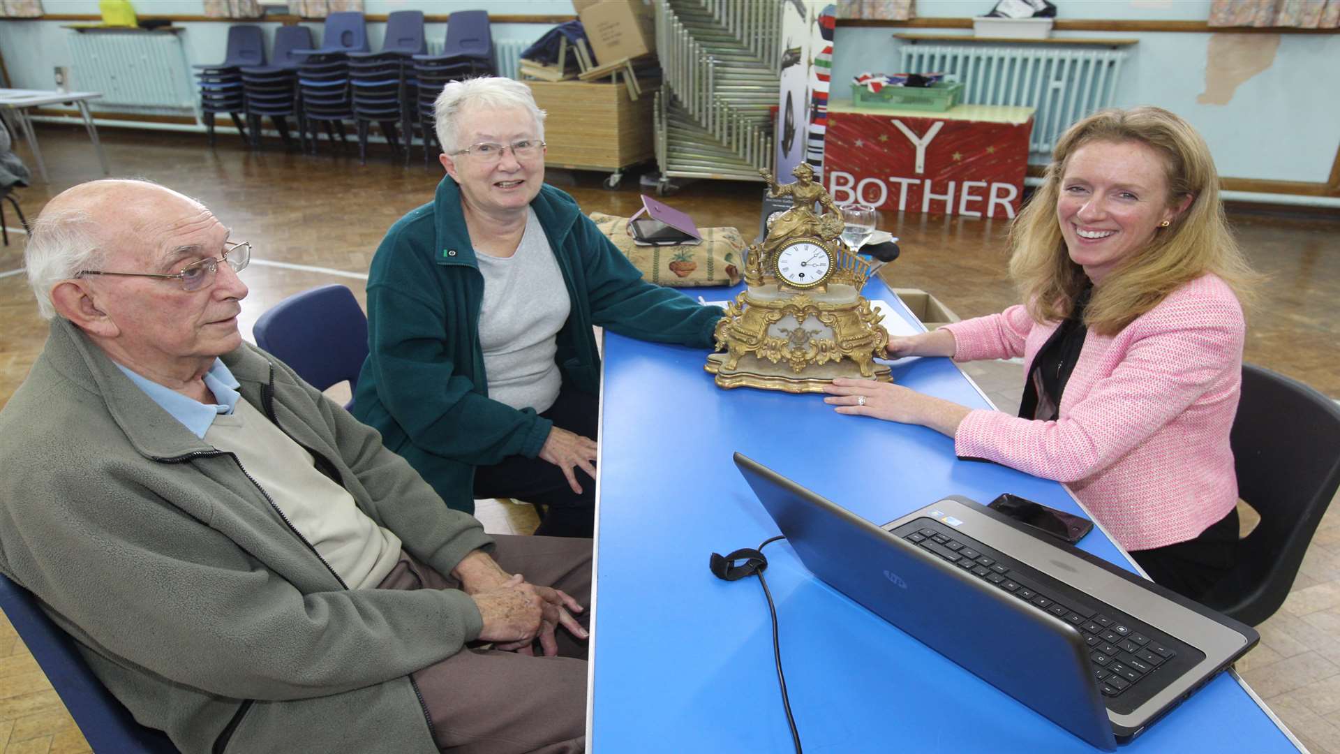 David Gable and his wife Maureen having a 19th Century French Mantle Clock being valued by auctioneer Cliona Kilroy