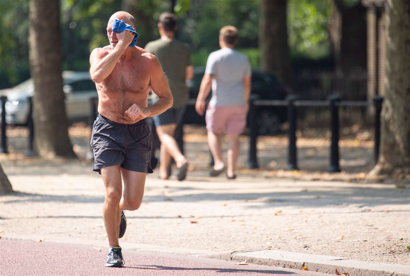 A hot day for a jog on the Mall (Dominic Lipinski/PA)