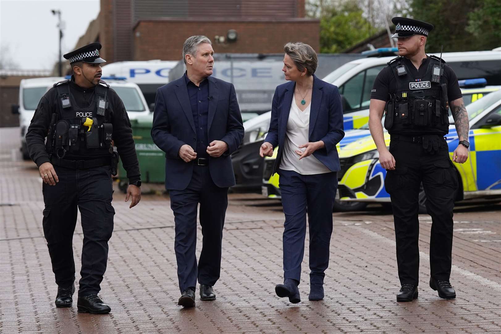 Labour leader Sir Keir Starmer with shadow home secretary Yvette Cooper talking to officers during a visit to Milton Keynes police station, Buckinghamshire (Stefan Rousseau/PA)