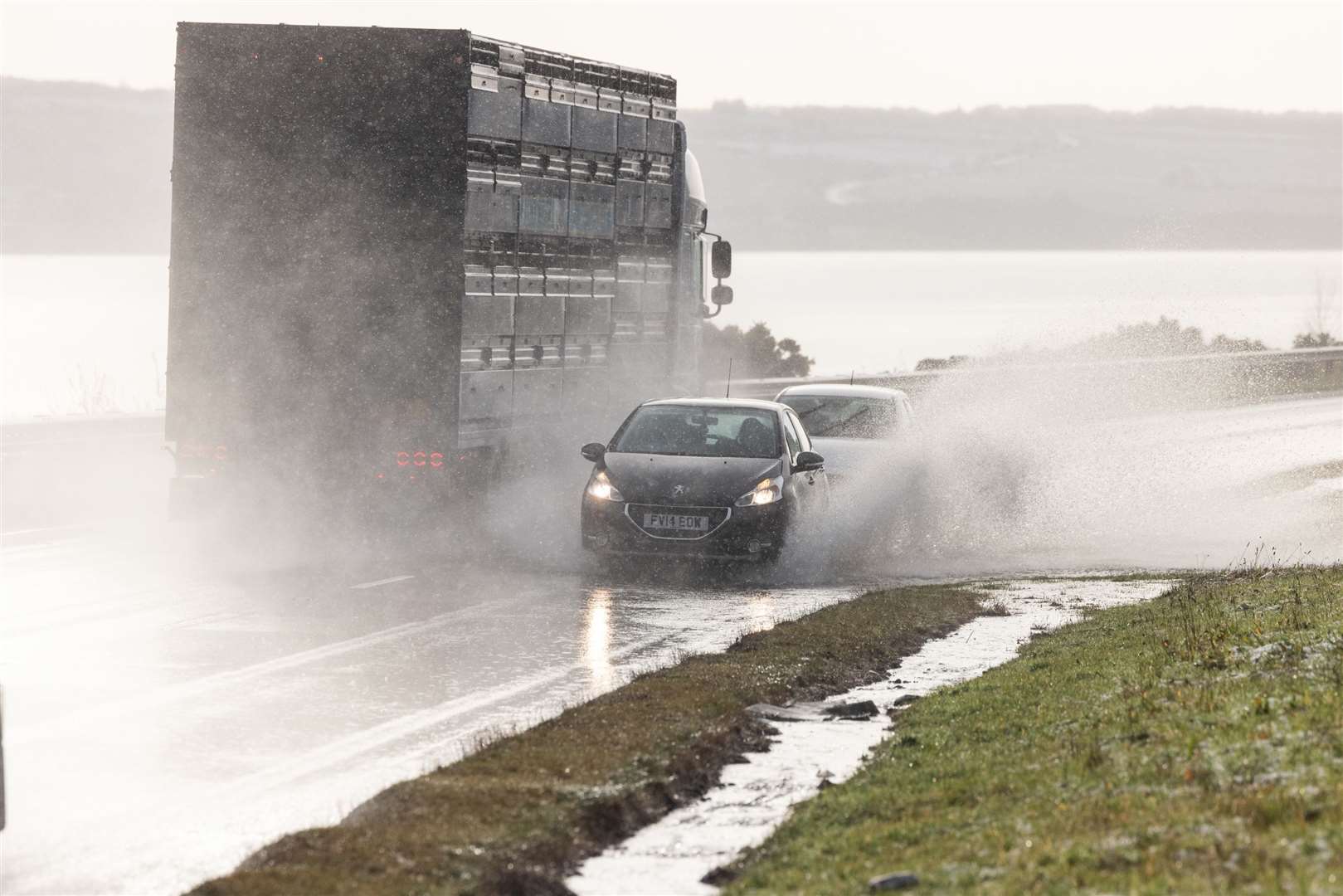 Vehicles on the A9 in Inverness, as snow, rain and wind warnings remain in place for the region on New Year’s Day (Paul Campbell/PA)