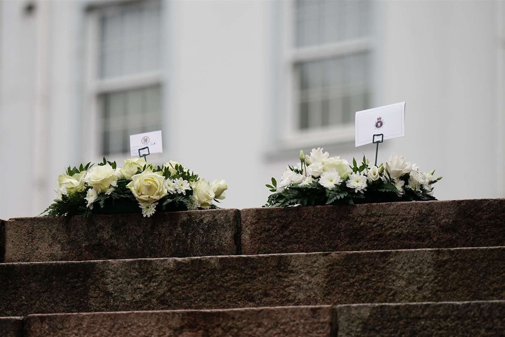 Flowers left near to the scene of an explosion and fire at a block of flats in St Helier (Aaron Chown/PA)