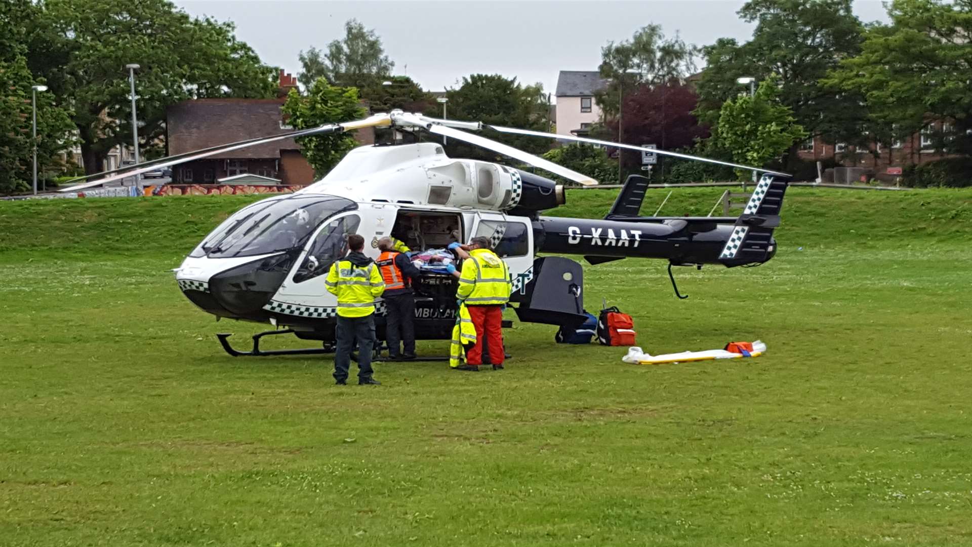 A patient is loaded into a helicopter