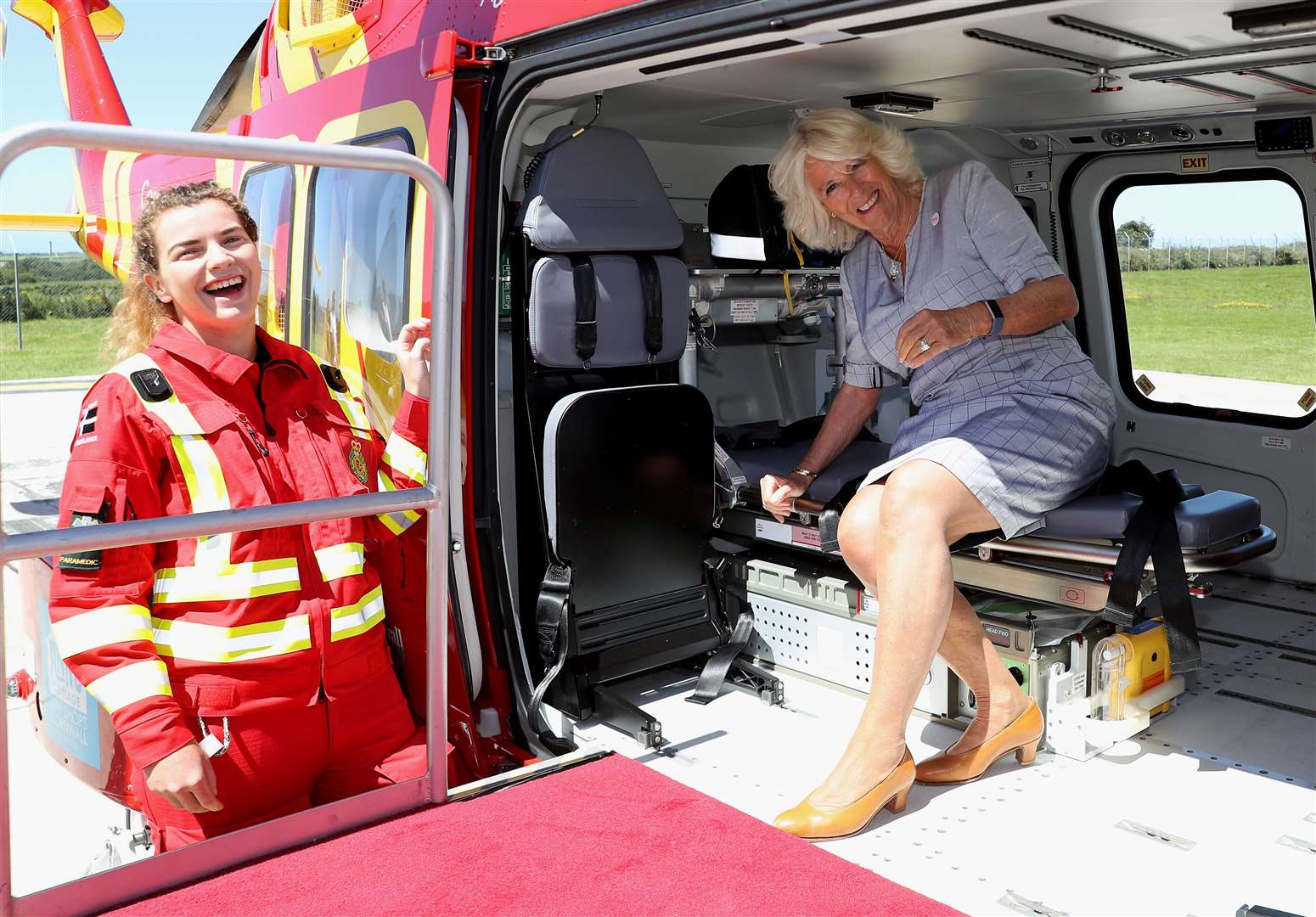 The Duchess of Cornwall speaks with a crew member as she launches the new helicopter (Chris Jackson/PA)