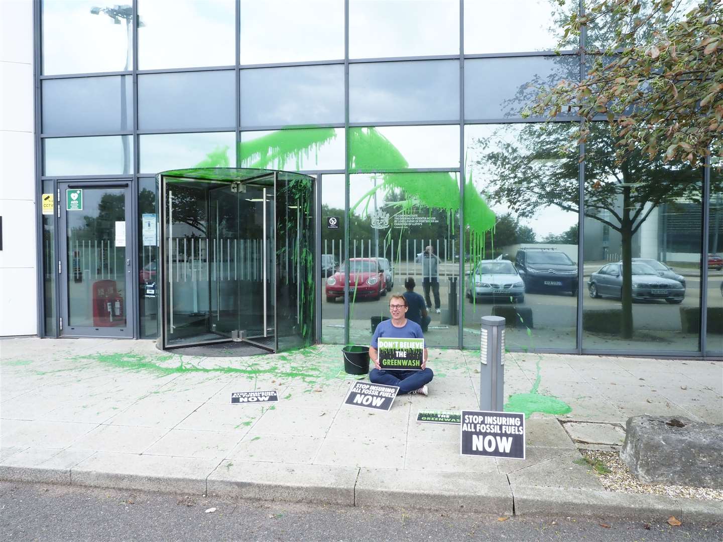 Protester Richard Eyre from Extinction Rebellion group Insurance Rebellion cover Lloyd's of London offices in green paint over company's support for fossil fuels. Picture: Richard Eyre