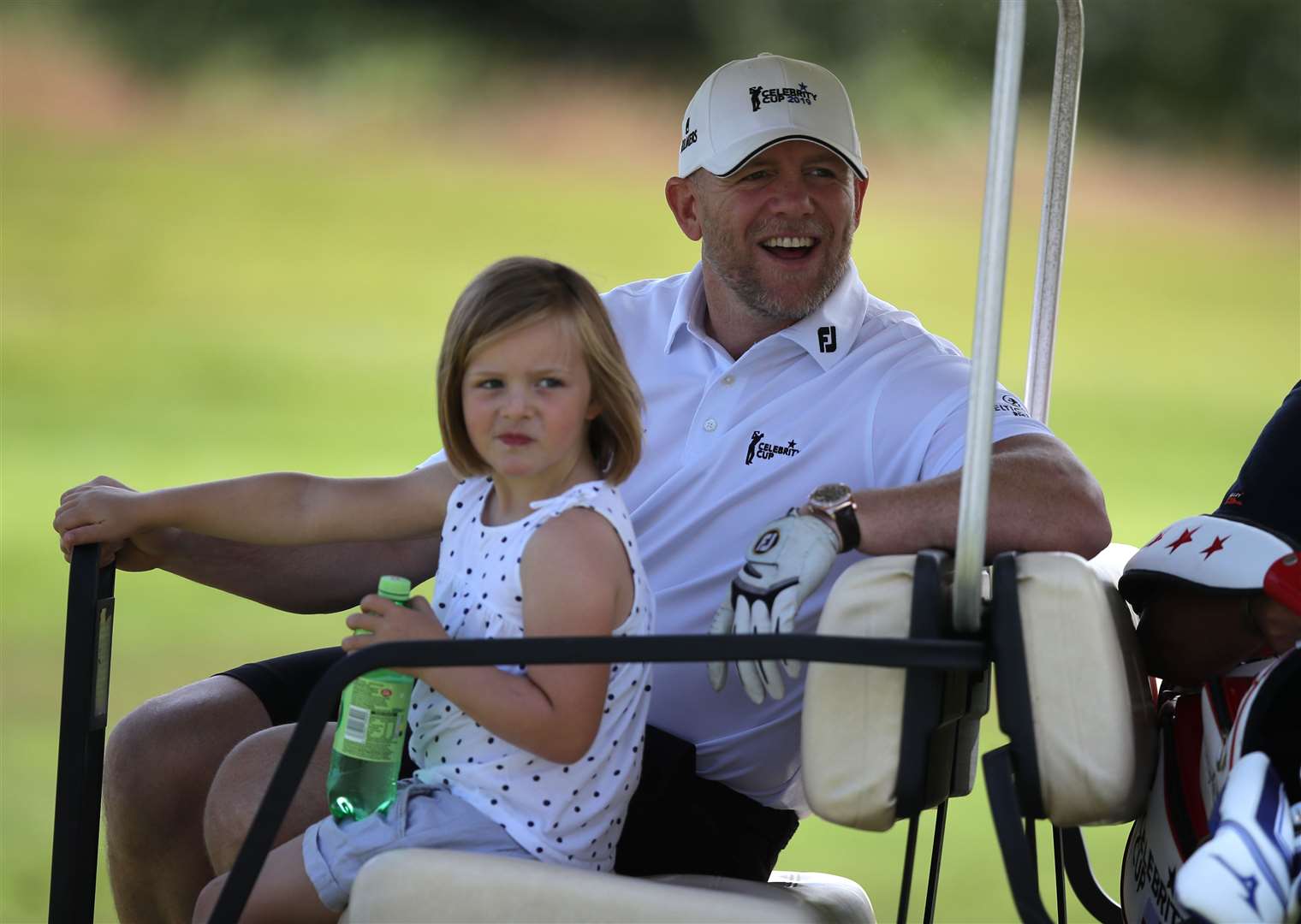 Mike Tindall rides on a golf cart with his daughter Mia during a Celebrity Cup charity fundraiser golf tournament (Andrew Matthews/PA)
