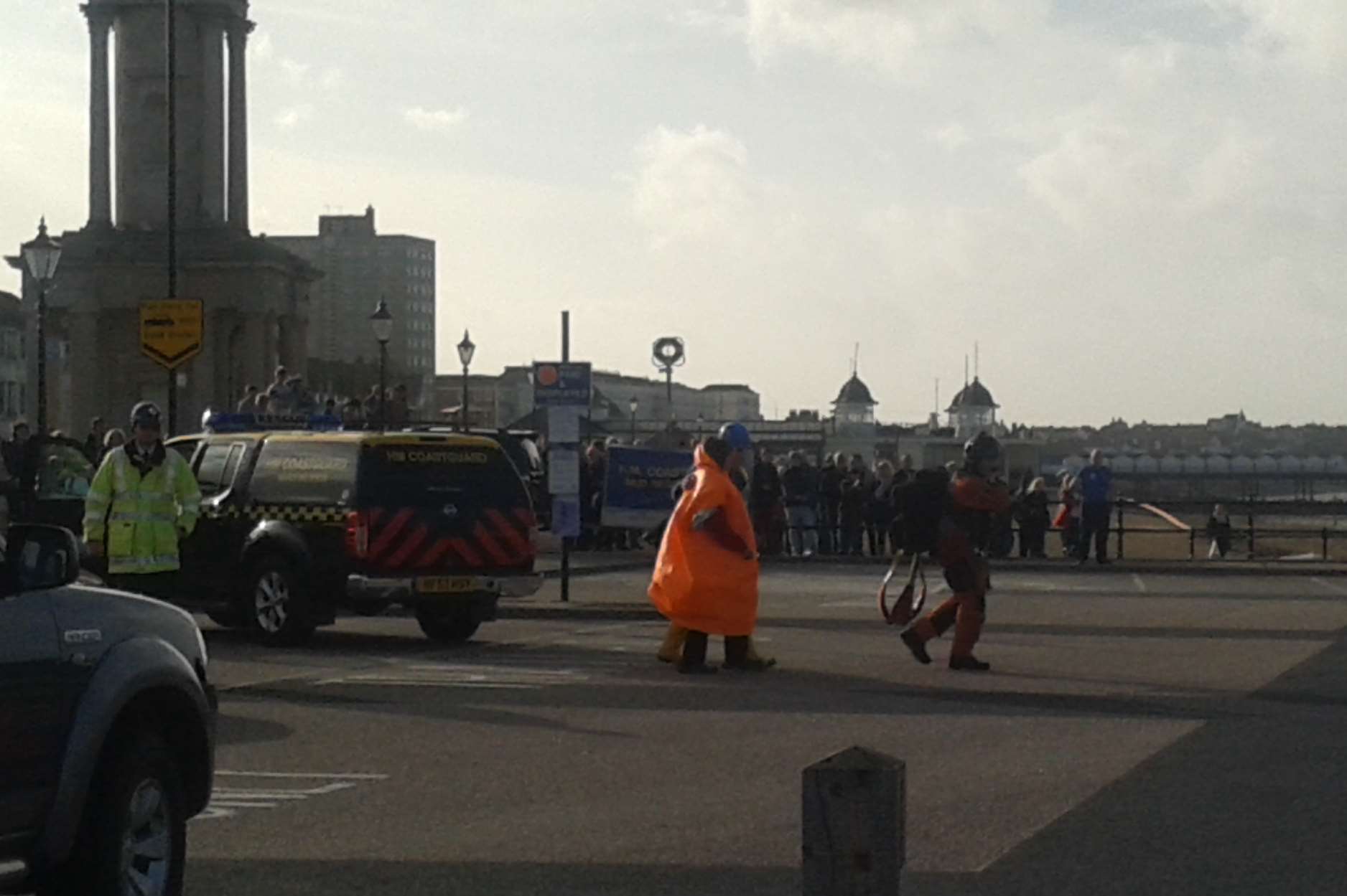 The woman is escorted to the rescue helicopter