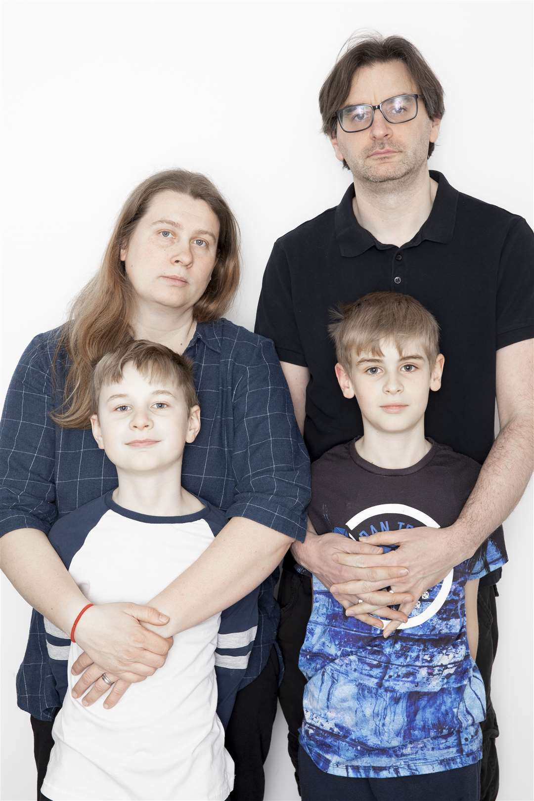Ukrainian mum-of-two Marina Hughes with her husband Phil and their children Thomas,10, and Timothy, 8, at their home in Sittingbourne. She is worried for her mother and grandmother, who has demenita, are still trapped in Kyiv as Putin's Russian army moves in