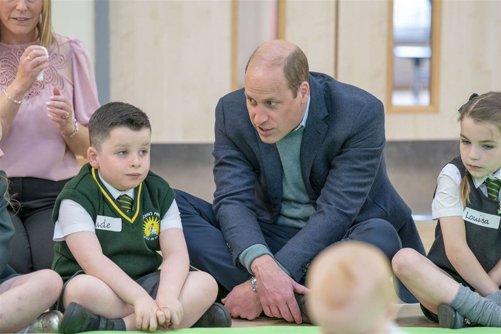 William chats to a pupil during the visit to the primary school (Jane Barlow/PA)