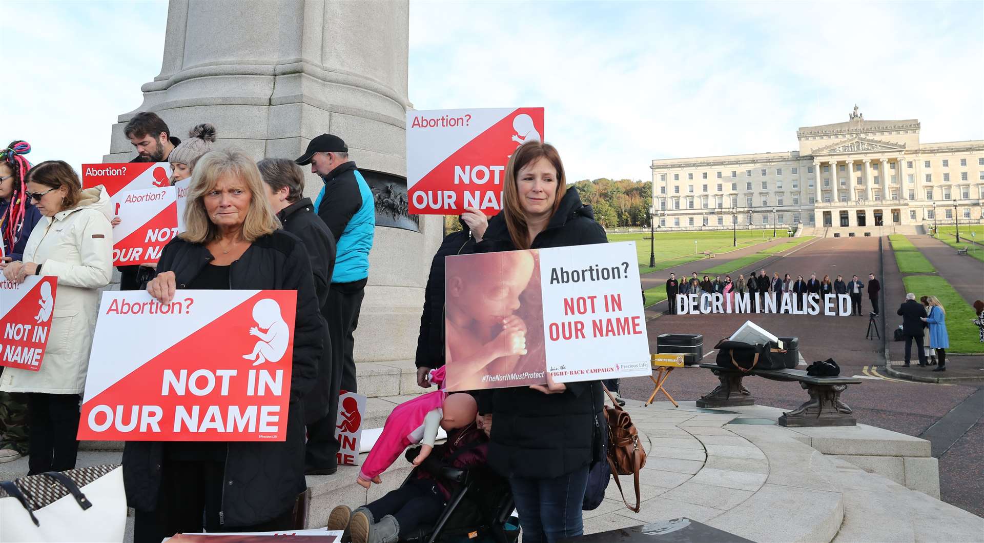 Anti-abortion and pro-choice activists take part in separate demonstrations at Stormont (Niall Carson/PA)