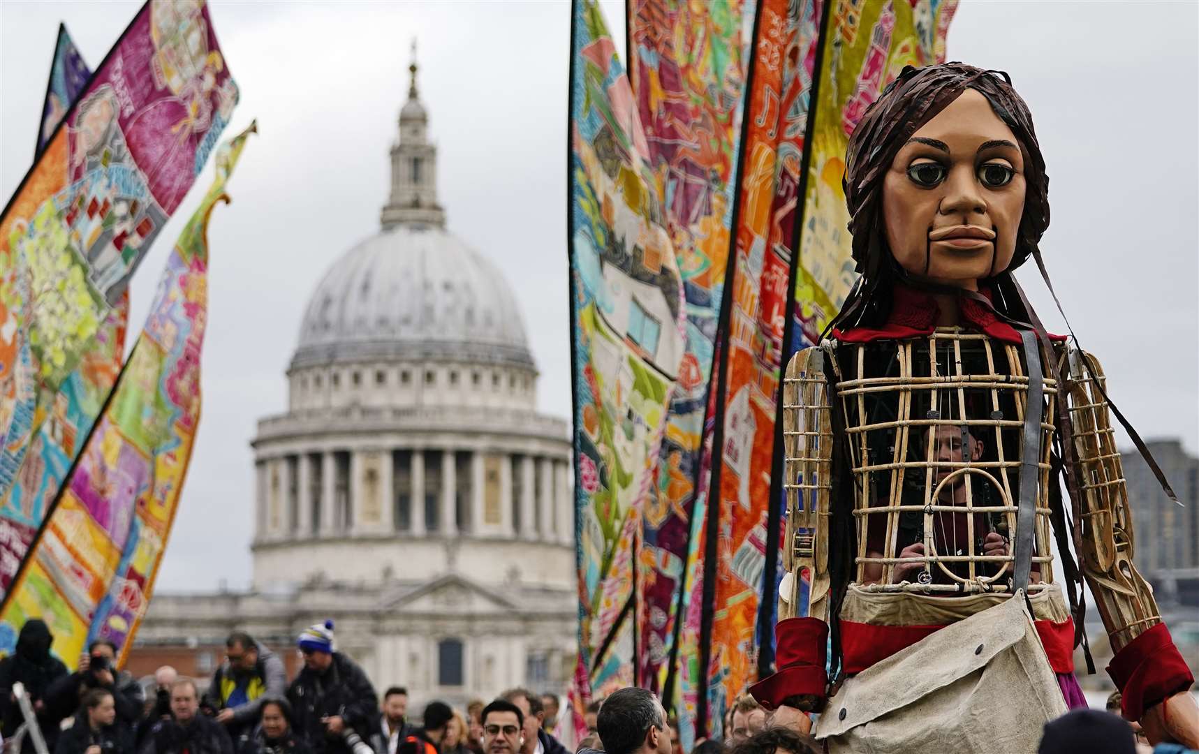 Little Ama walks over Millennium Bridge in London as part of The Walk (Aaron Chown/PA)